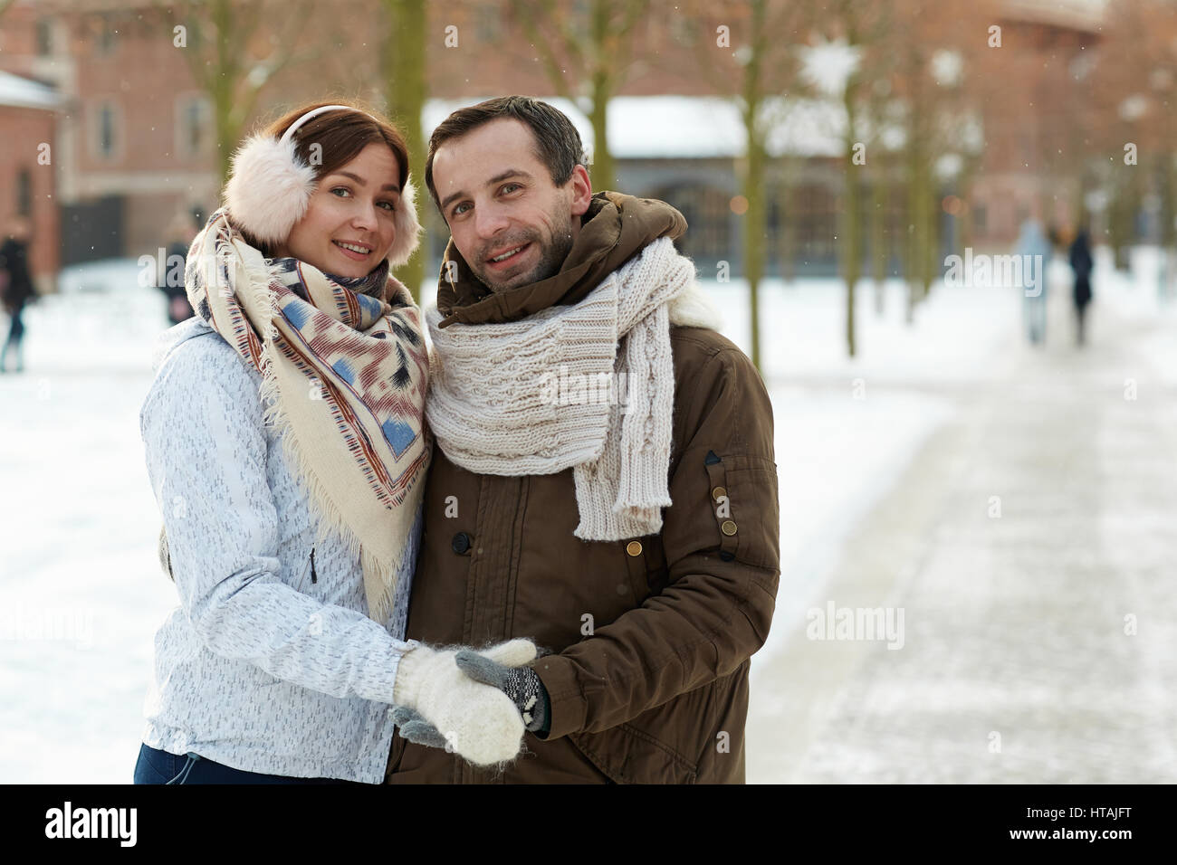 Amorous couple in embrace taking walk in park Stock Photo