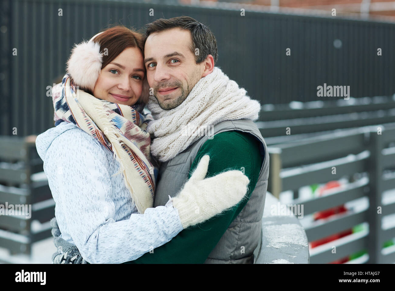 Affectionate man and woman in embrace looking at camera Stock Photo