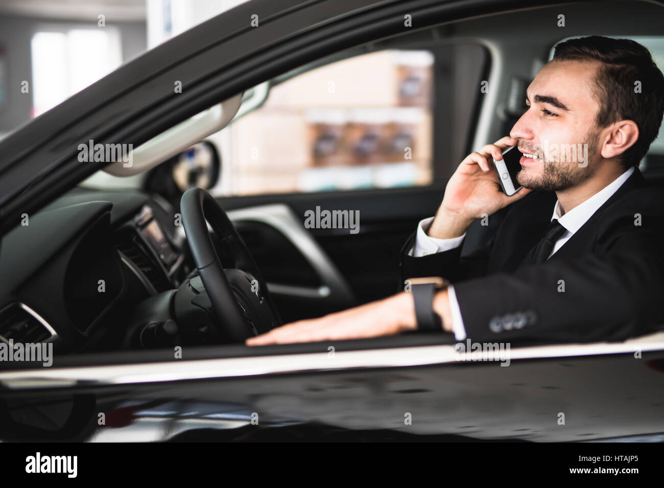Portrait handsome business man use phone in car Stock Photo - Alamy