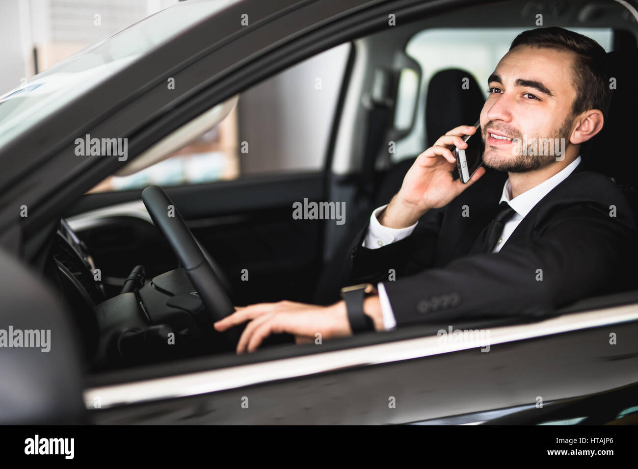 Portrait handsome business man use phone in car Stock Photo - Alamy