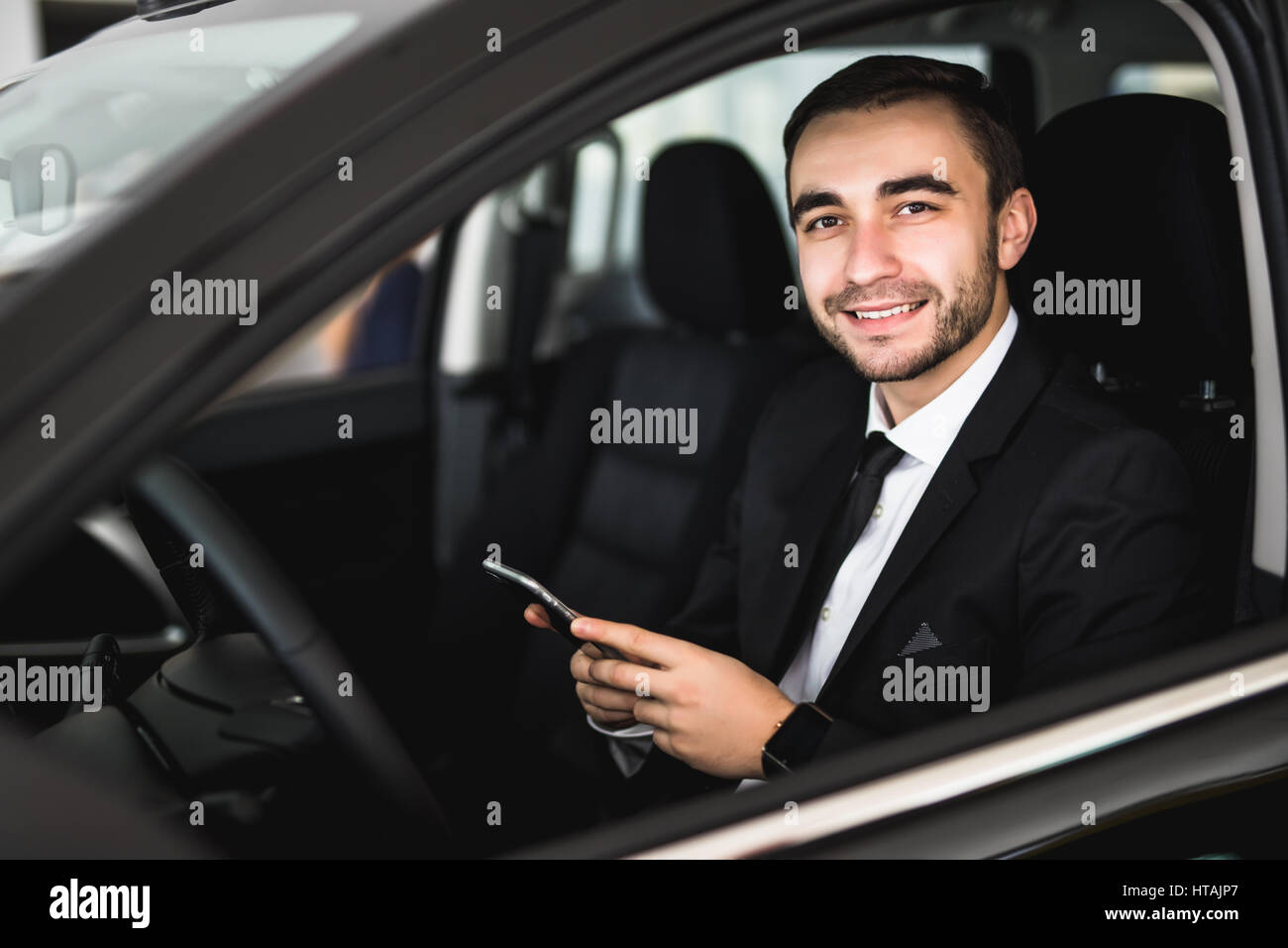 Portrait handsome business man use phone in car Stock Photo - Alamy