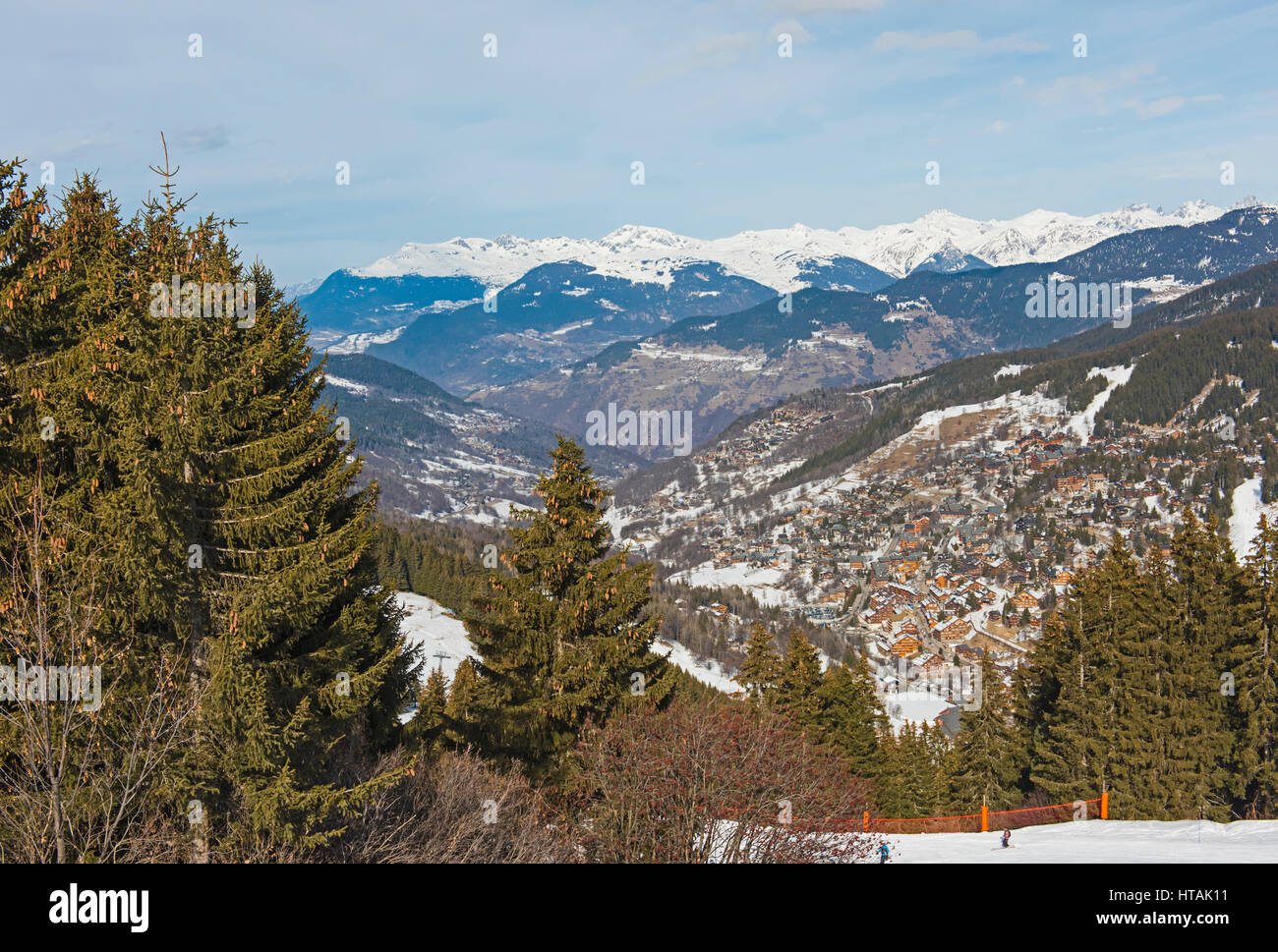 Panoramic view down snow covered valley in alpine mountain range with ...