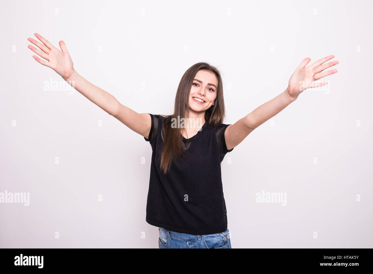 Young woman points to the strong hands on a gray background. Stock Photo