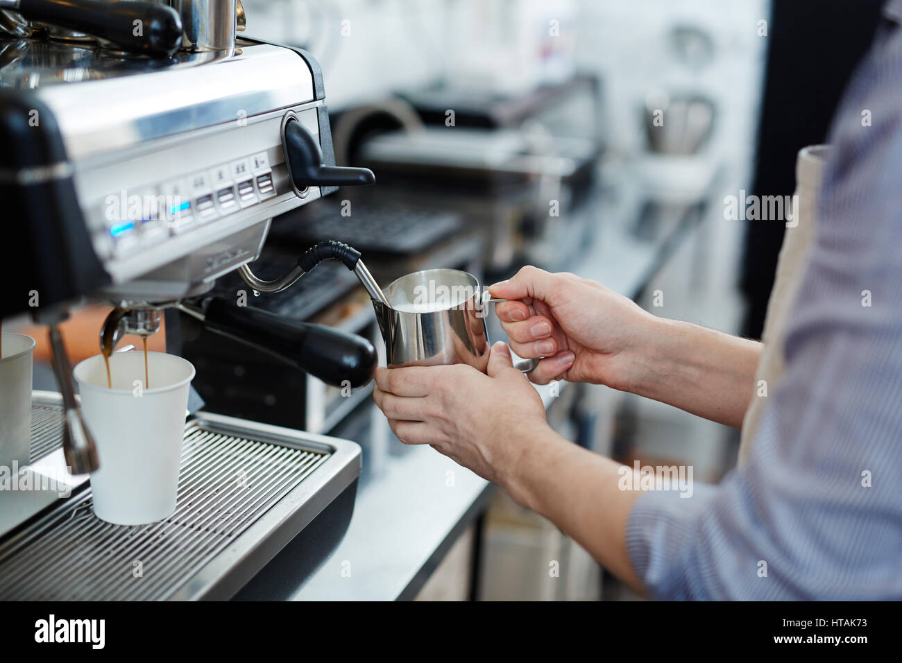 Barista frothing milk for cappuccino Stock Photo Alamy