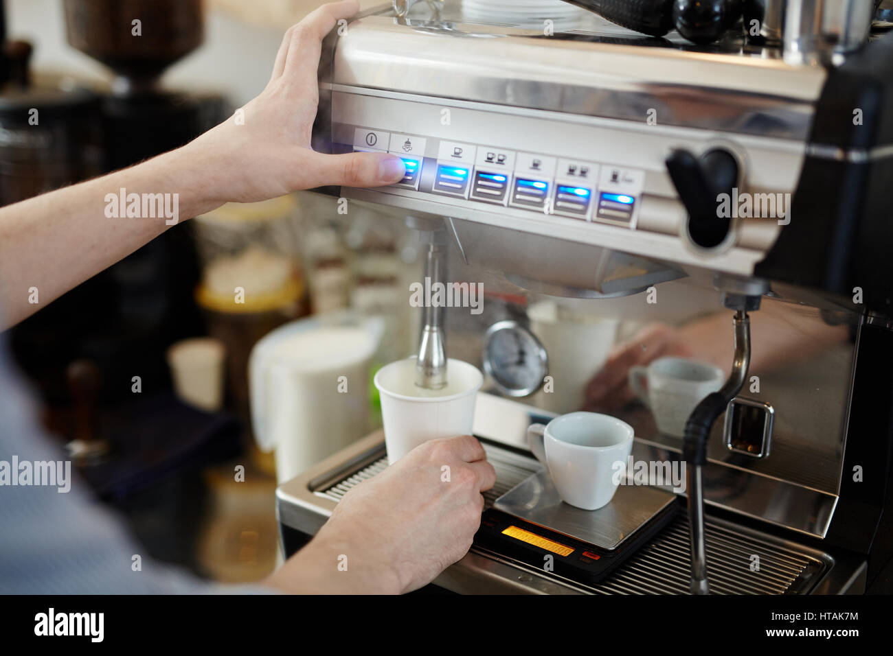 Barista pushing steam button to froth milk for cappuccino Stock Photo ...