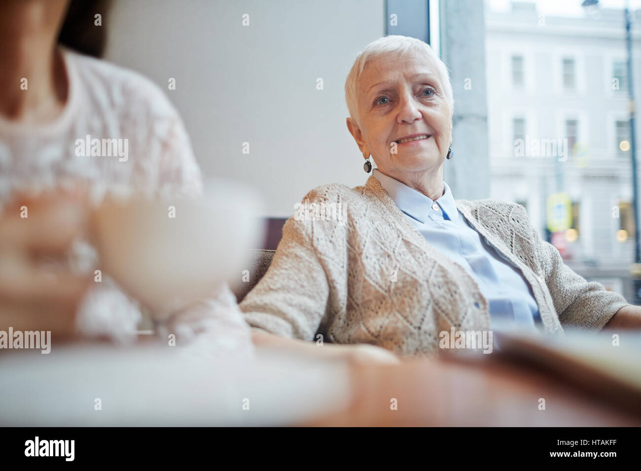 Grey haired grandmother sitting hi-res stock photography and images - Alamy