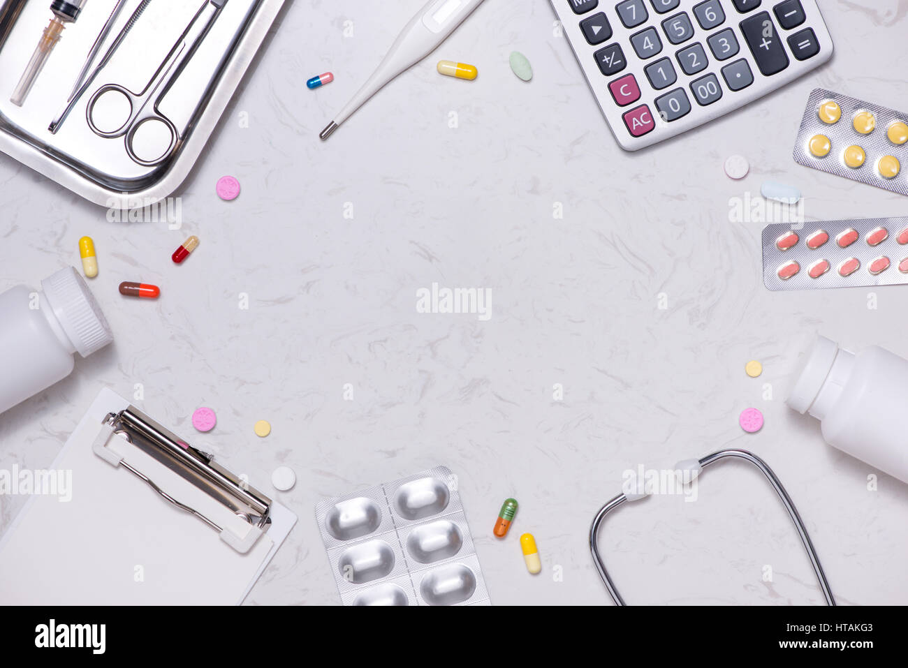 Workplace of a doctor. Stethoscope, clipboard, pills and other stuff on ...