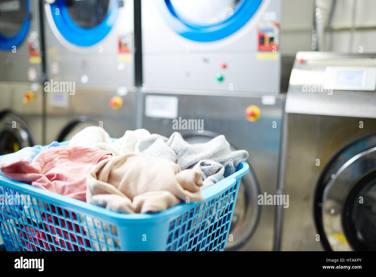 Basket with clothes in laundromat Stock Photo Alamy