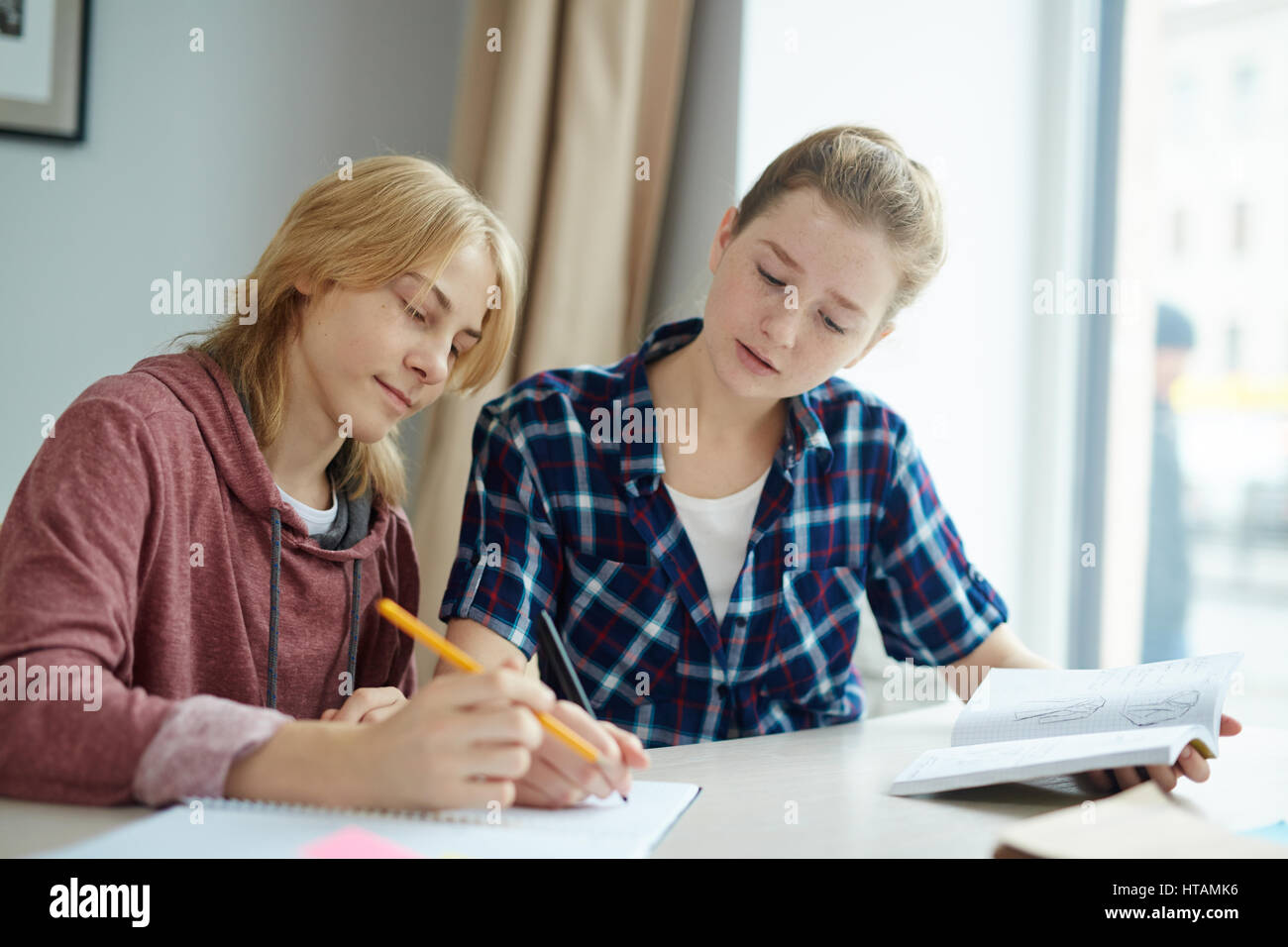 Two college students making group task in class Stock Photo