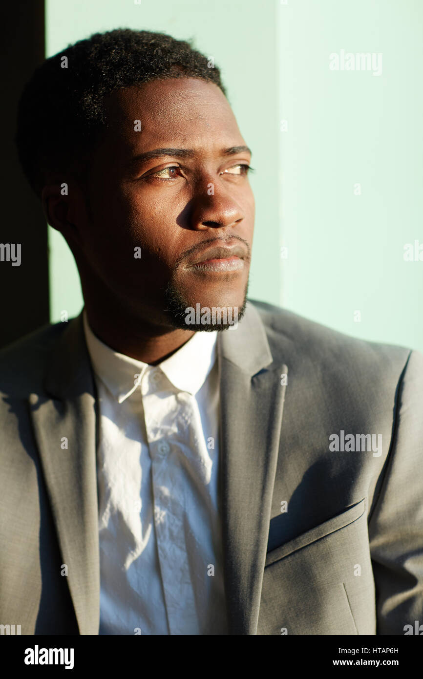 Business portrait of young handsome African-American man standing in ...