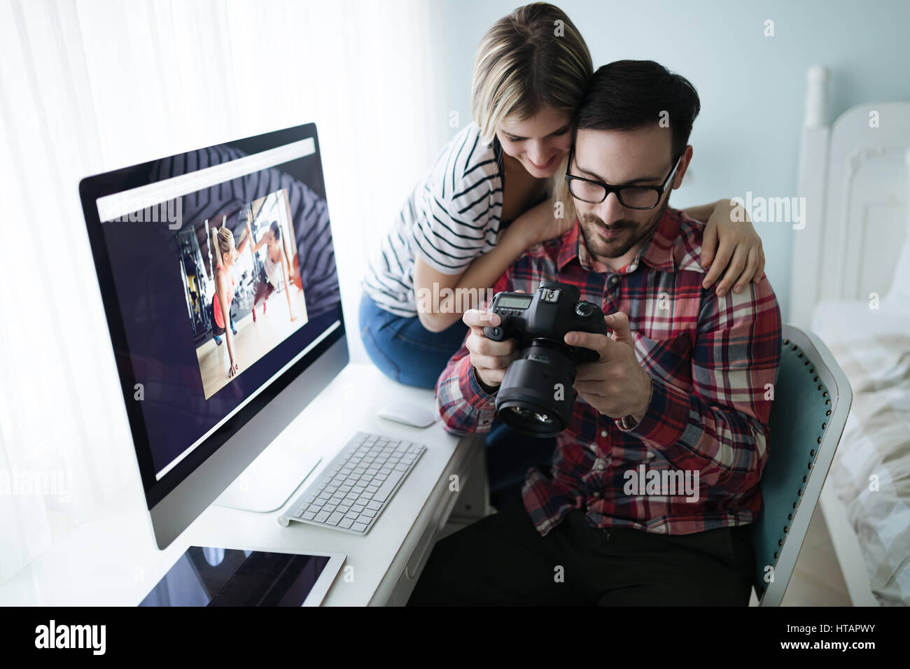 Couple in love working from home on design project Stock Photo