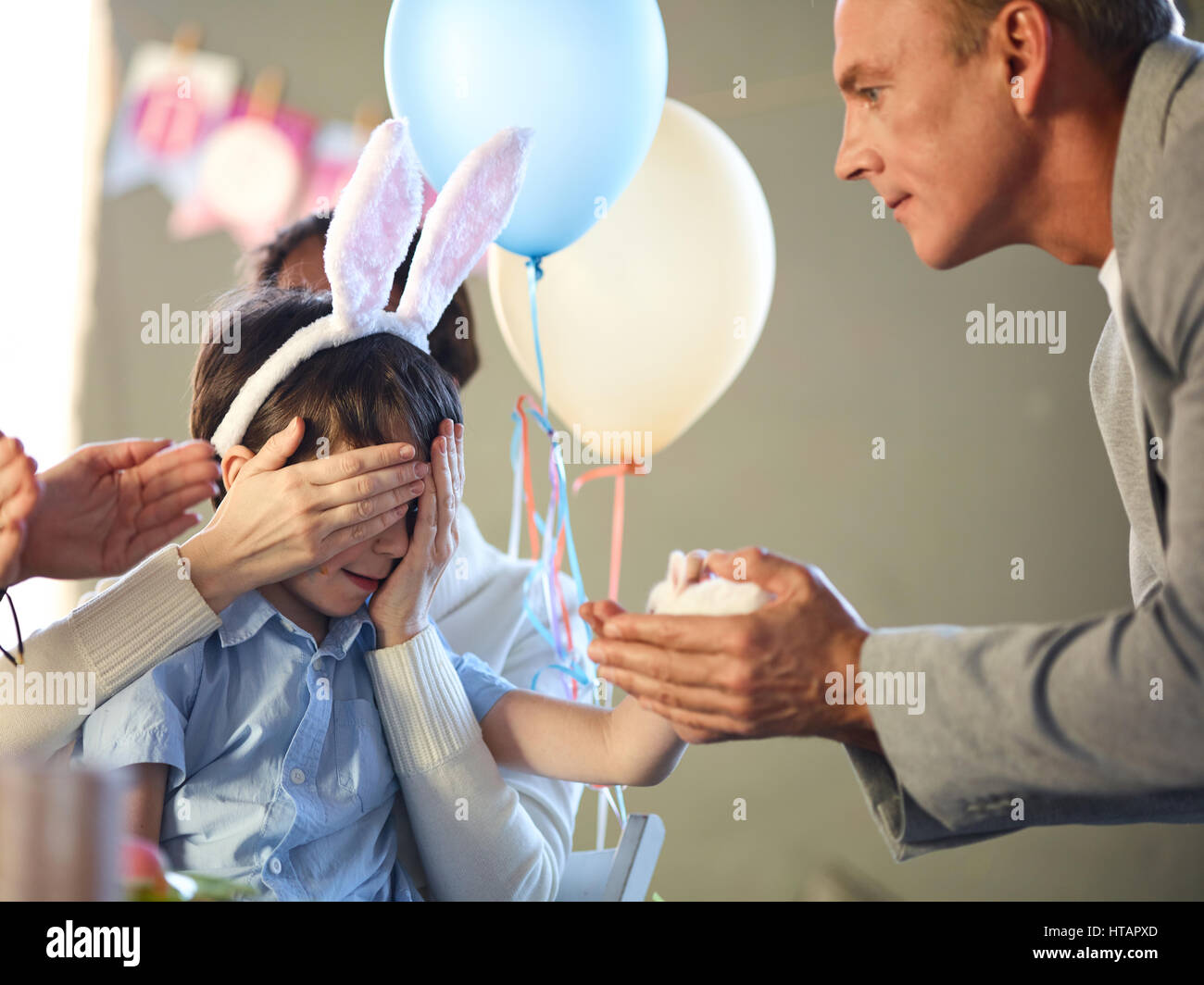 Father holding small rabbit in palms to give it to his son Stock Photo ...