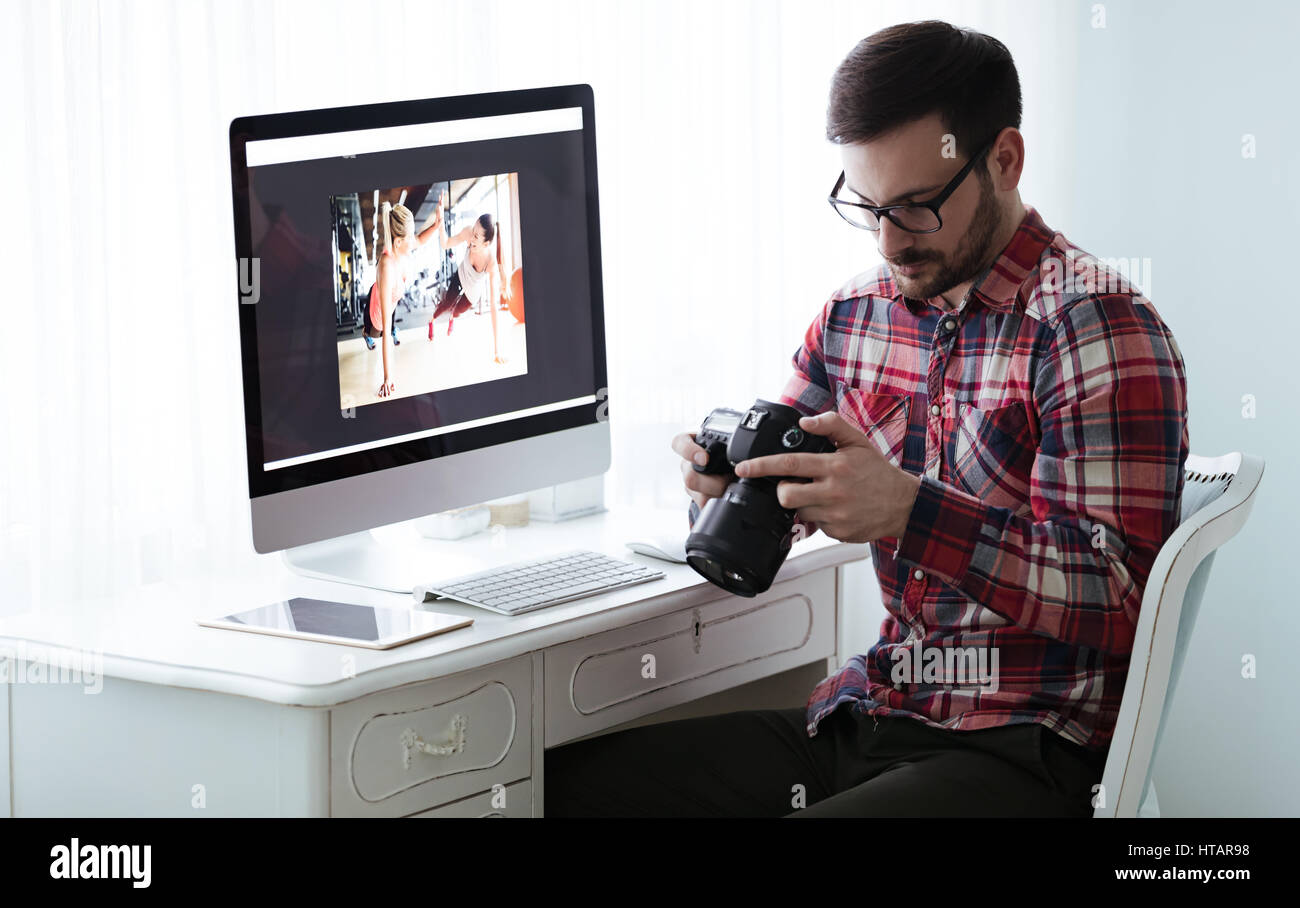 Photographer retoucher working on photos and editing on desktop Stock ...