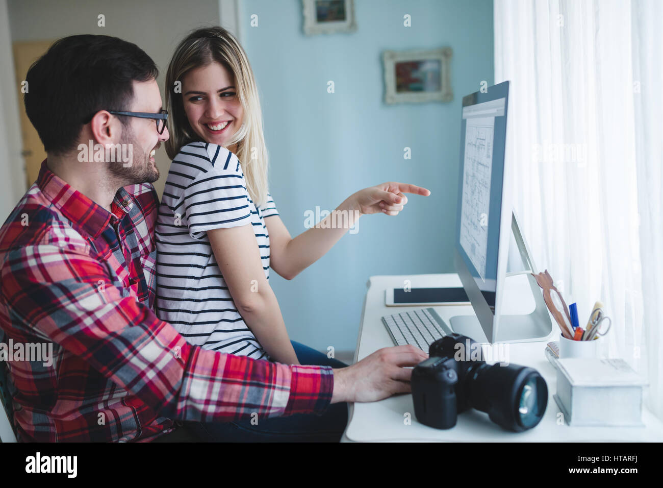 Couple in love working from home on design project Stock Photo