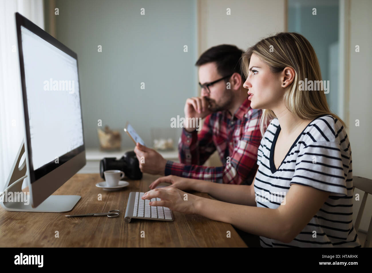 Couple in love working from home on design project Stock Photo