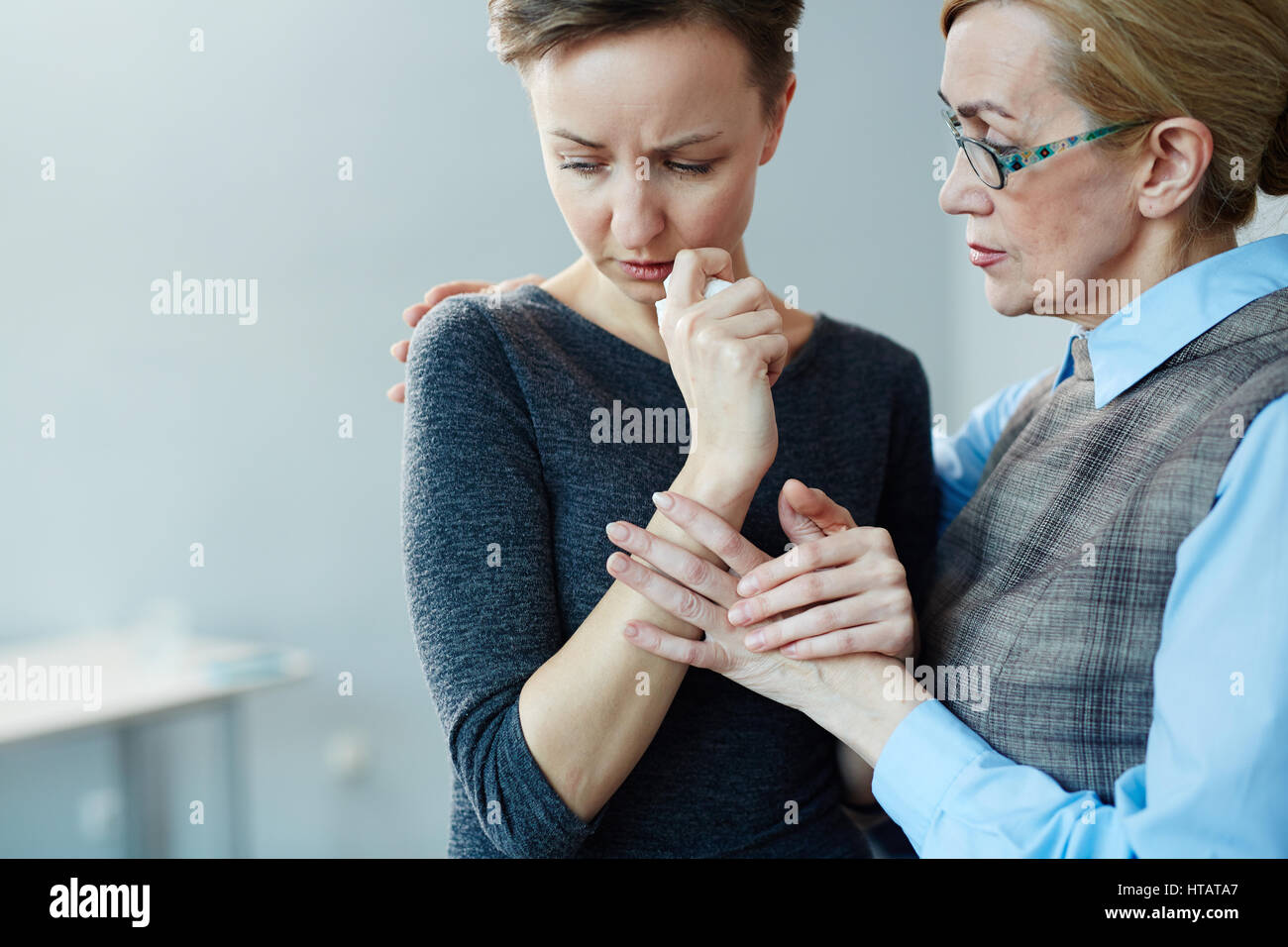 Crying woman and her psychologist Stock Photo
