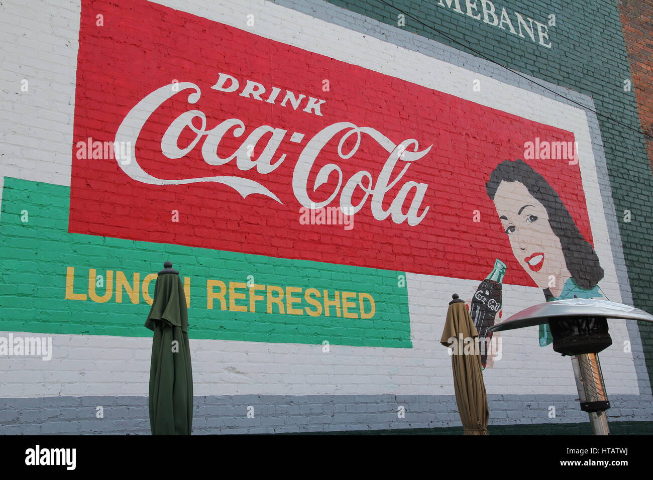 Coca cola sign painted on brick wall Stock Photo