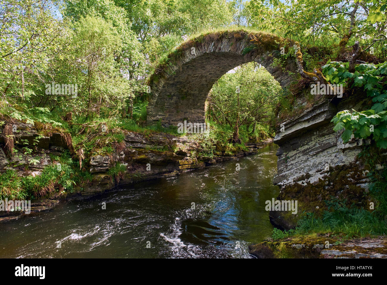 The remains of The Old Bridge of Livet that crosses the river Livet in the Scottish Highlands.UK. Stock Photo