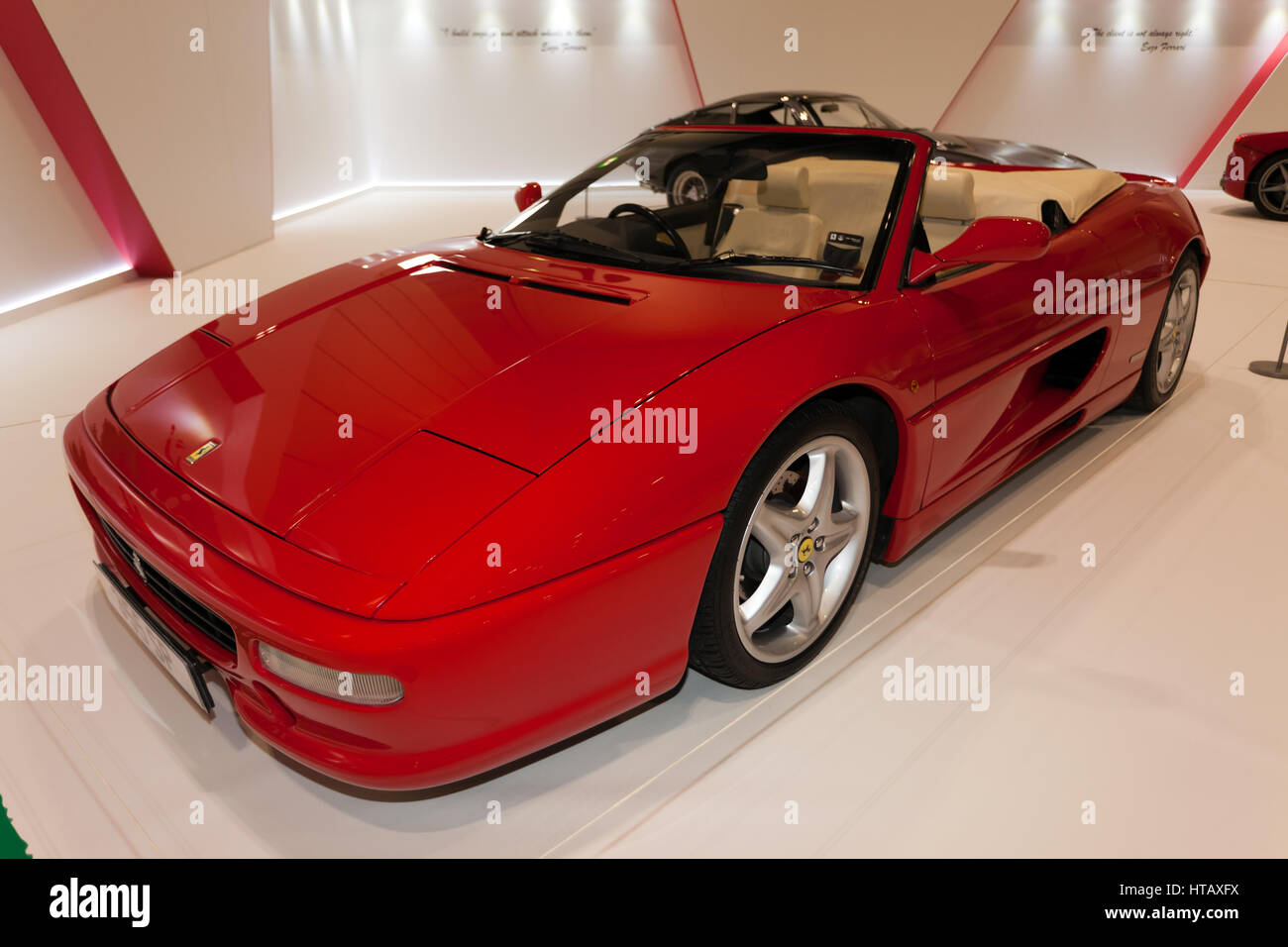 A three-quarter front view of a red,  Ferrari F355 Spider F1,  part of the Ferrari Tribute Collection at the 2017 London Classic Car Show Stock Photo