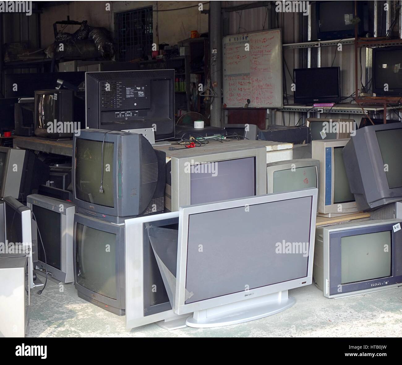 KAOHSIUNG, TAIWAN -- OCTOBER 17, 2015: A local store for the repair and recycling of traditional and flat screen televisions. Stock Photo