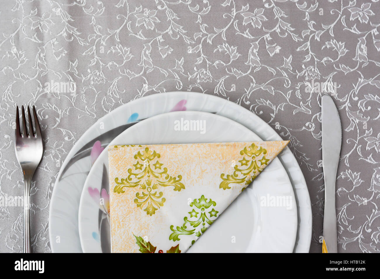 cutlery and plates with napkin on the table arranged for Saint day Stock Photo