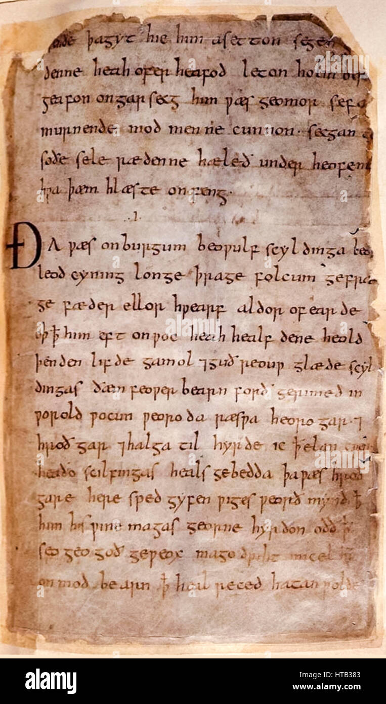 ‘Beowulf’ a page from the only surviving medieval manuscript of the epic Anglo-Saxon poem now held in the British Library in London and believed to date from the early 11th century. The pages shows evidence of fire damage dating from 1731 when the house in which it was stored caught fire. Stock Photo
