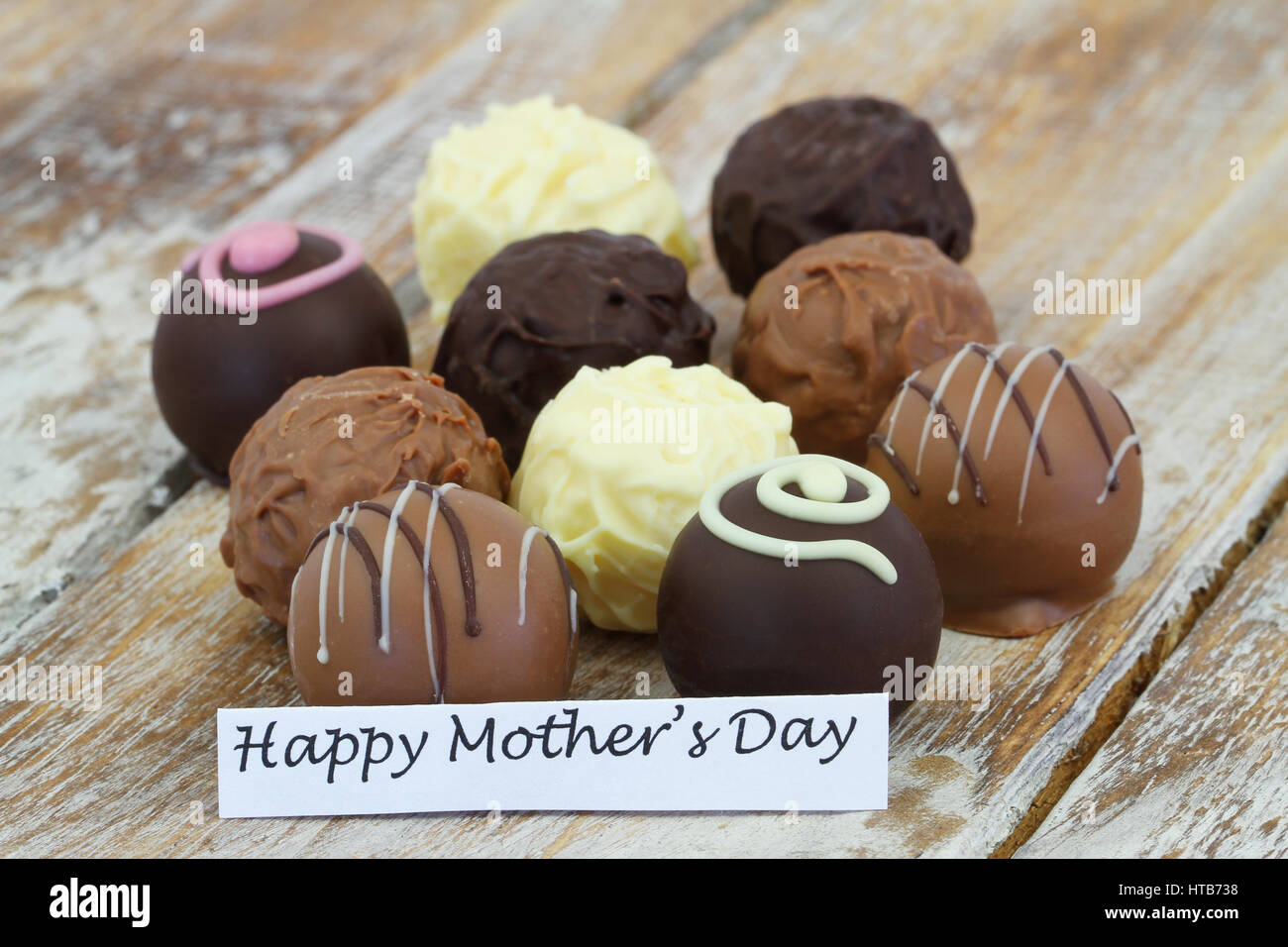 Happy Mother's day card with assorted chocolates on rustic wooden surface Stock Photo