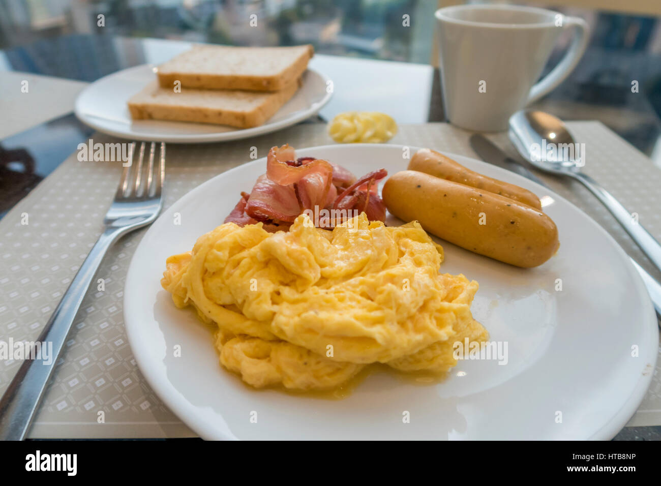 Breakfast with scambled eggs, sausage and bacon Stock Photo Alamy