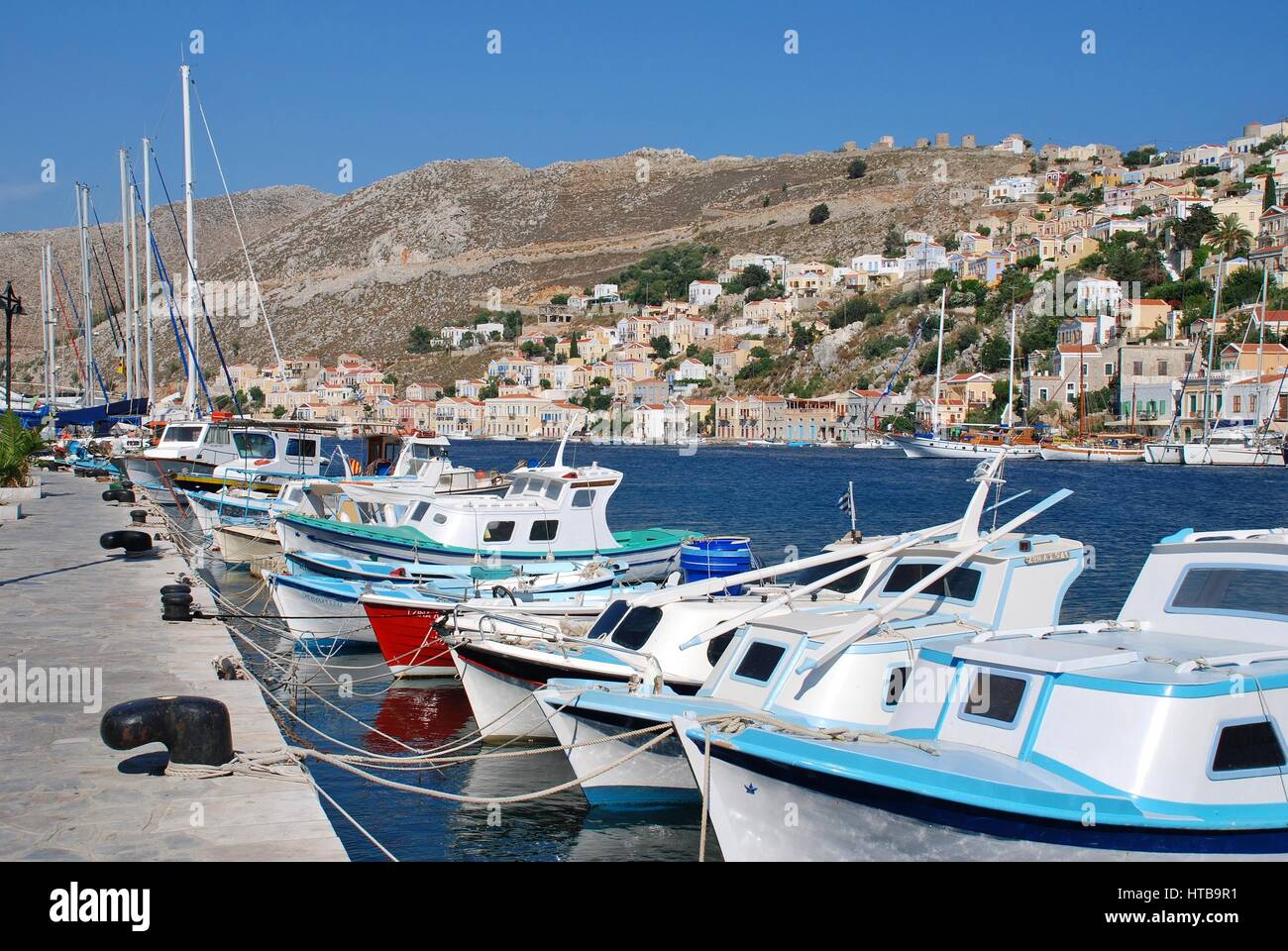 Boats moored in Yialos harbour on the Greek island of Symi. Stock Photo