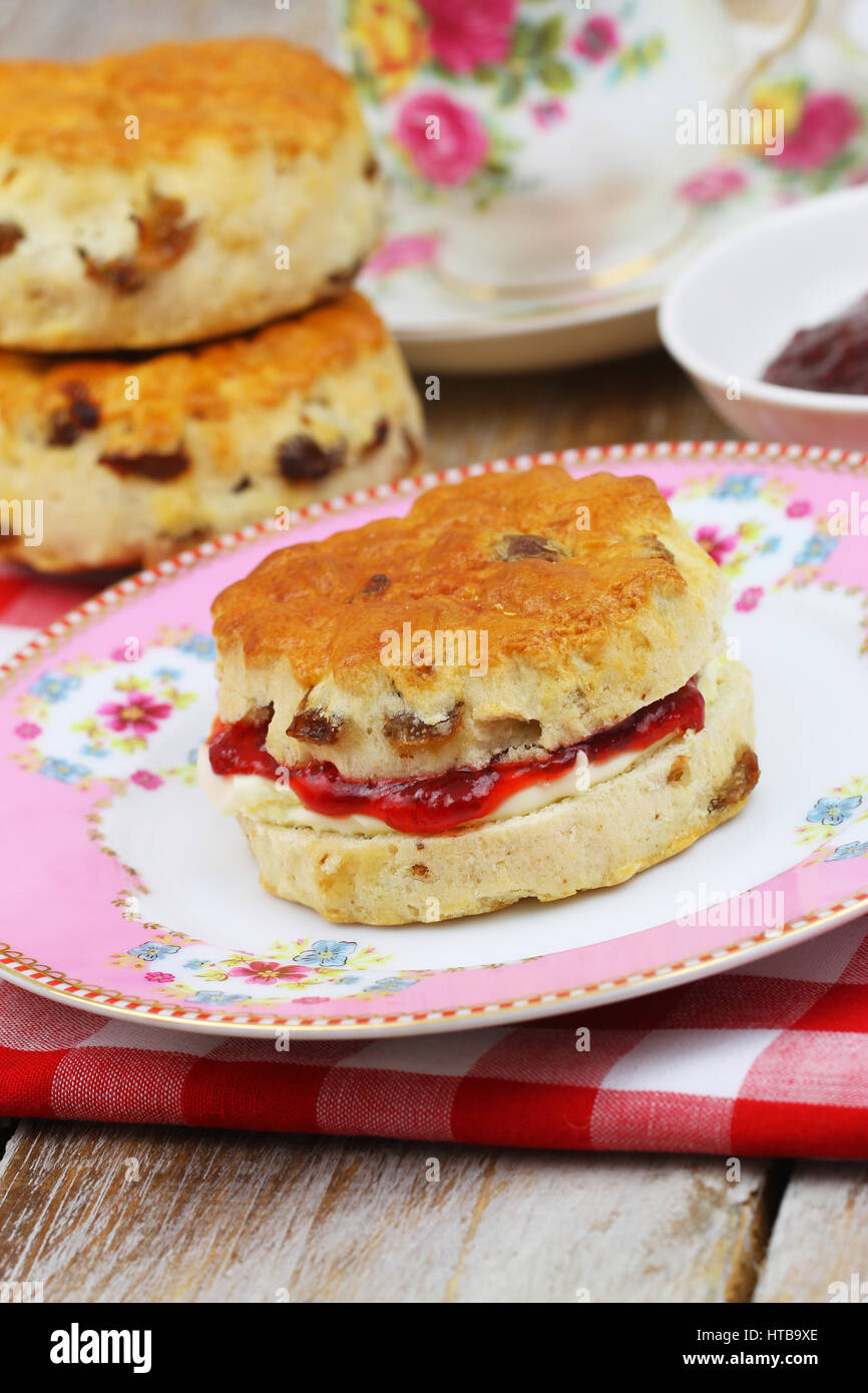 Traditional scone with strawberry jam and clotted cream Stock Photo