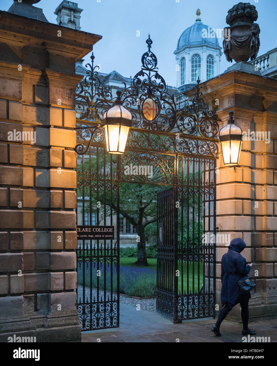 Students leaving Clare College, Cambridge at dusk, England, UK Stock Photo