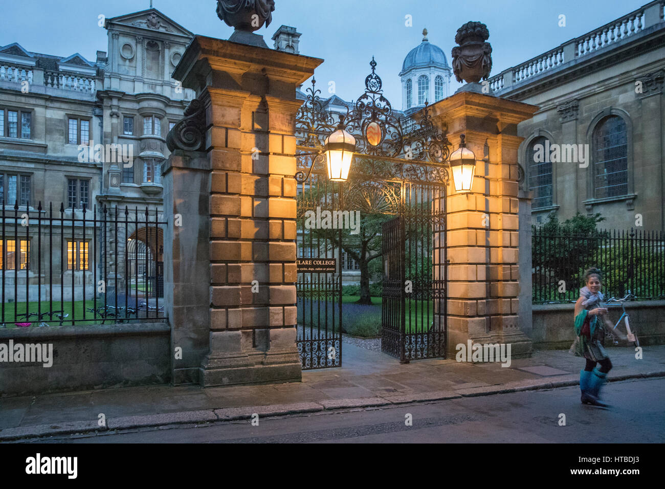 Students leaving Clare College, Cambridge at dusk, England, UK Stock Photo