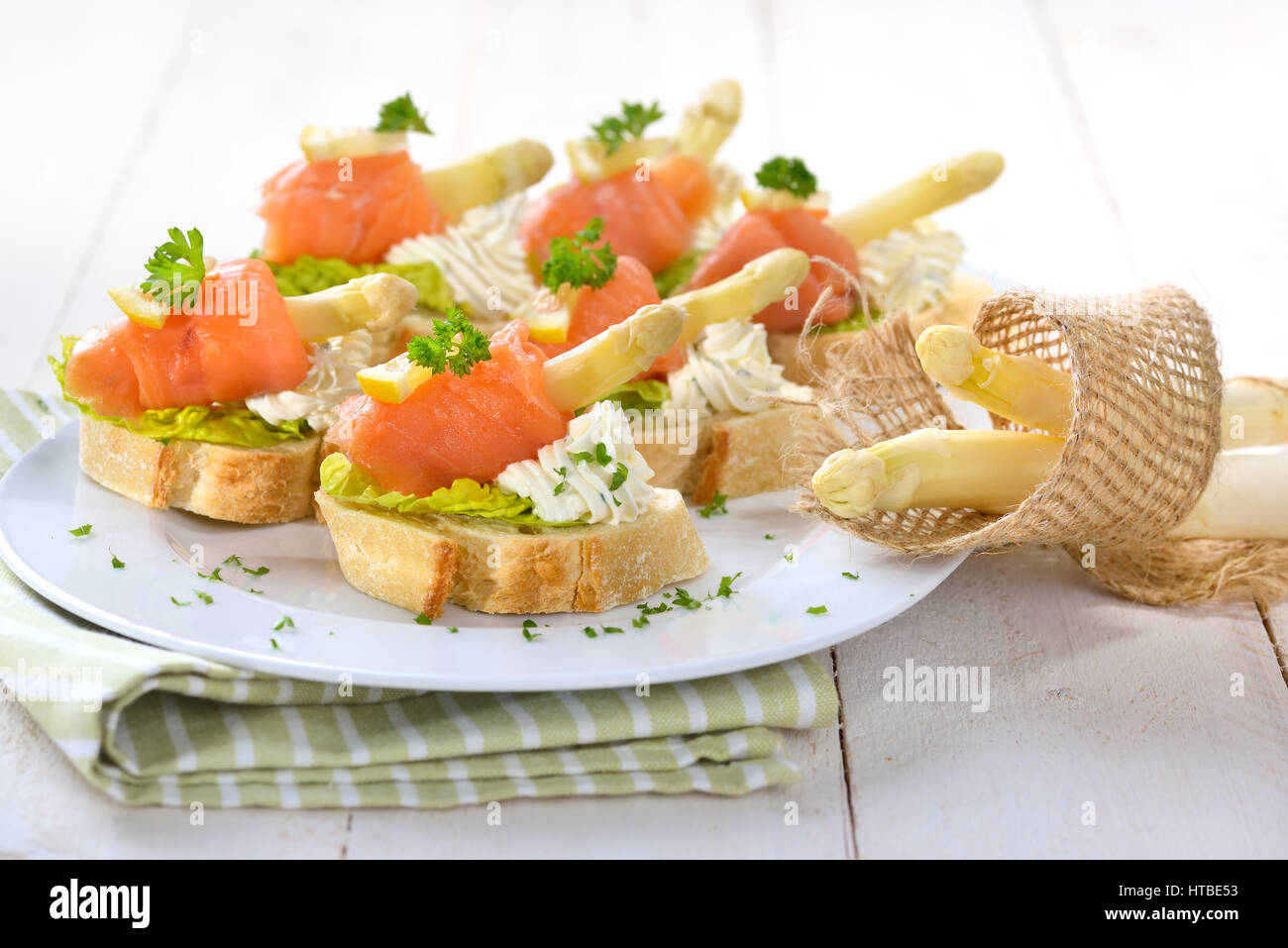 Delicious canapes with German white asparagus, cream cheese with herbs