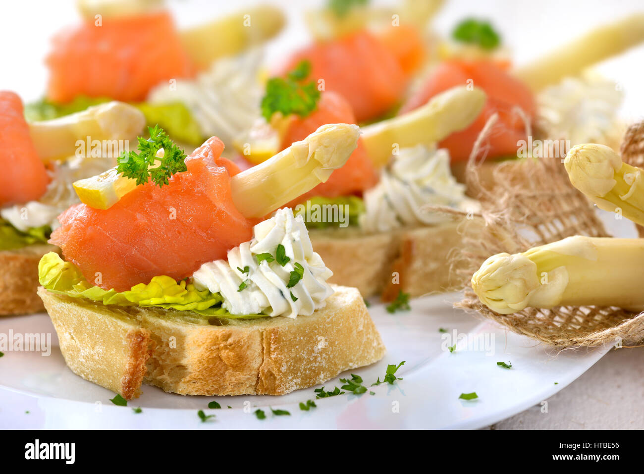 Delicious canapes with German white asparagus, cream cheese with herbs