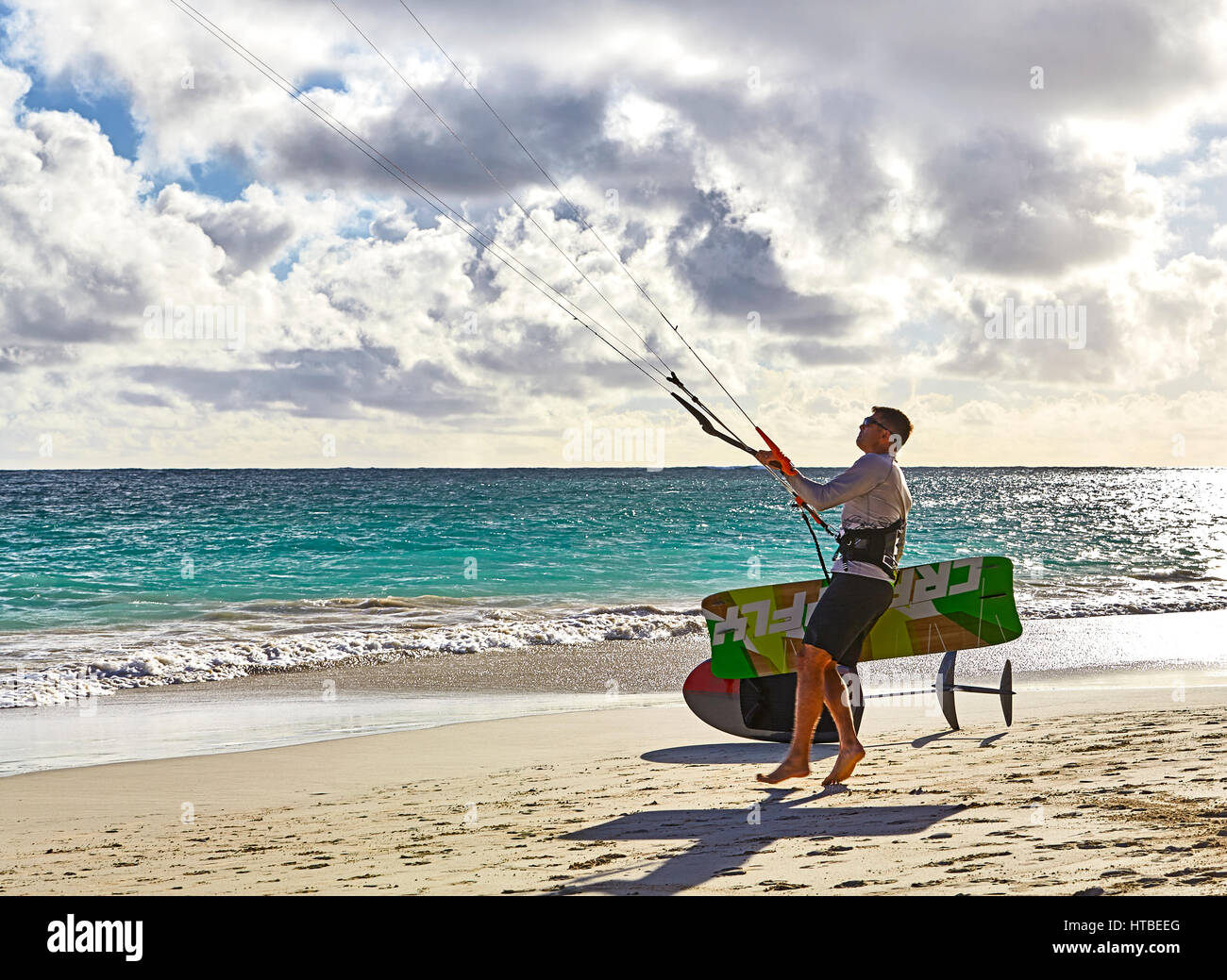 Kailua, Hawaii, USA - July 30, 2016: An unidentified man prepares to kitesurf in the early morning on the beach at Kailua Bay in Hawaii Stock Photo