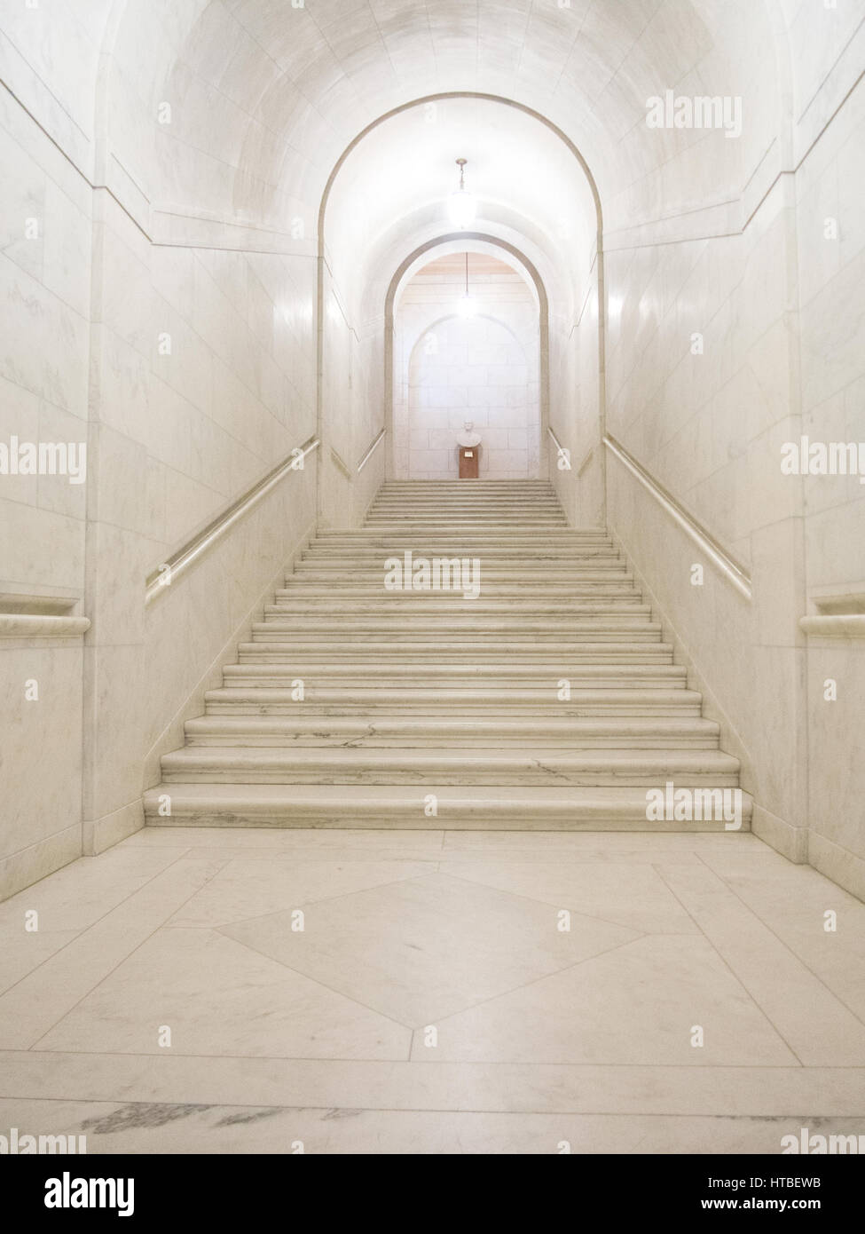 A white marble hallway with stairs inside the United States Supreme Court Building in Washington, DC. Stock Photo