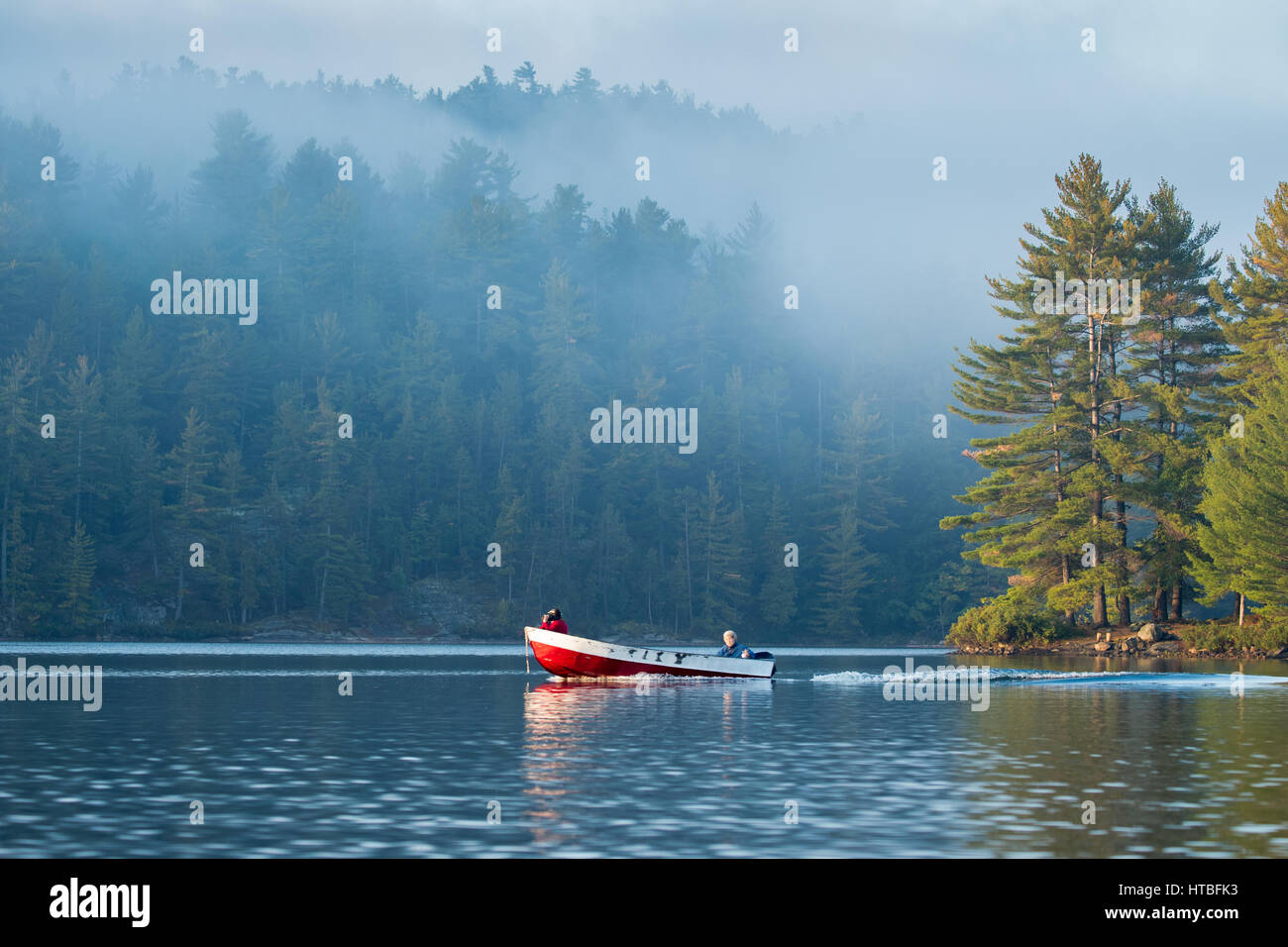 A boat on Charlton Lake at dawn, Ontario, Canada Stock Photo
