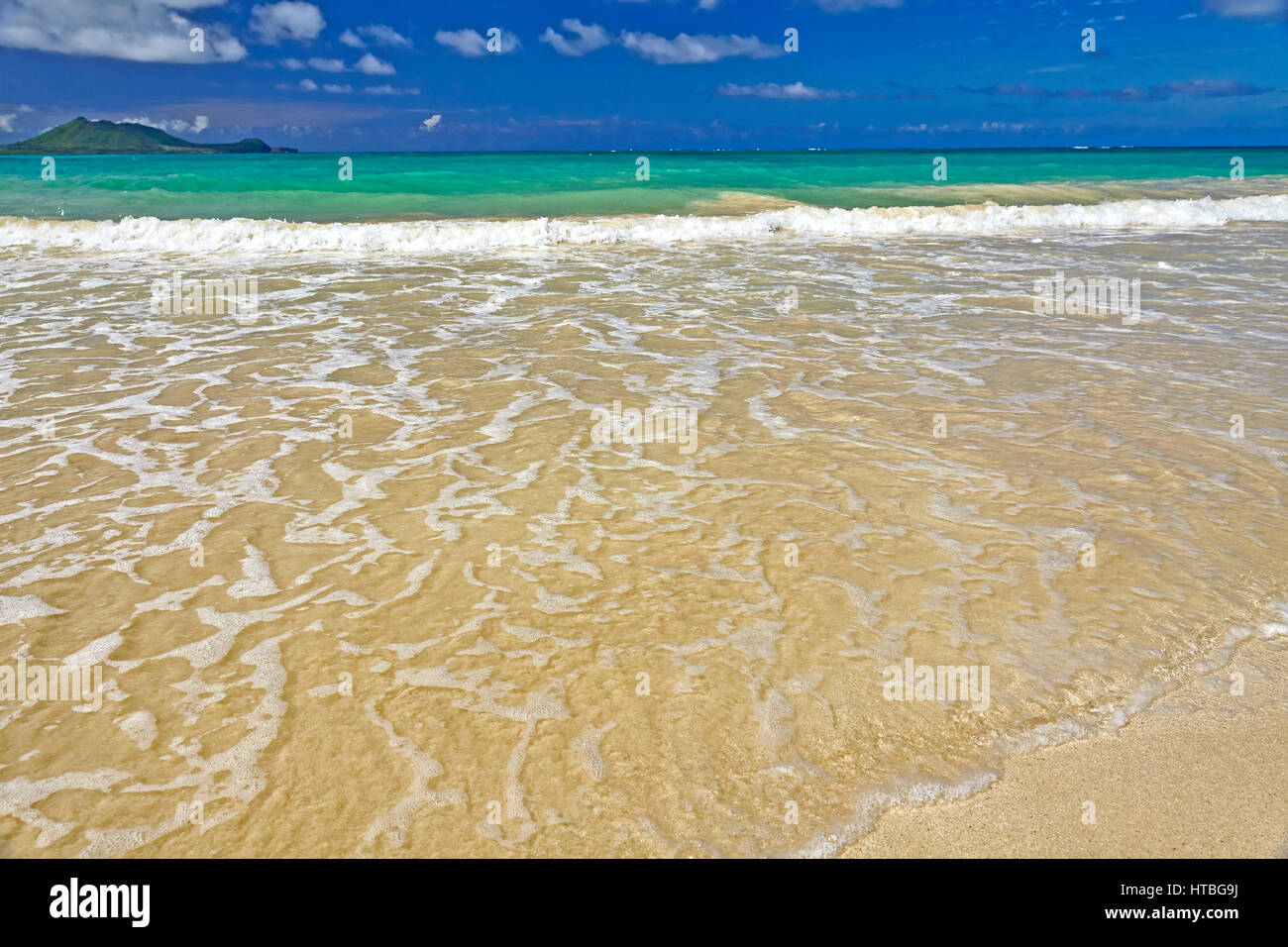 Exotic tropical island sandy beach and surf and sky Stock Photo