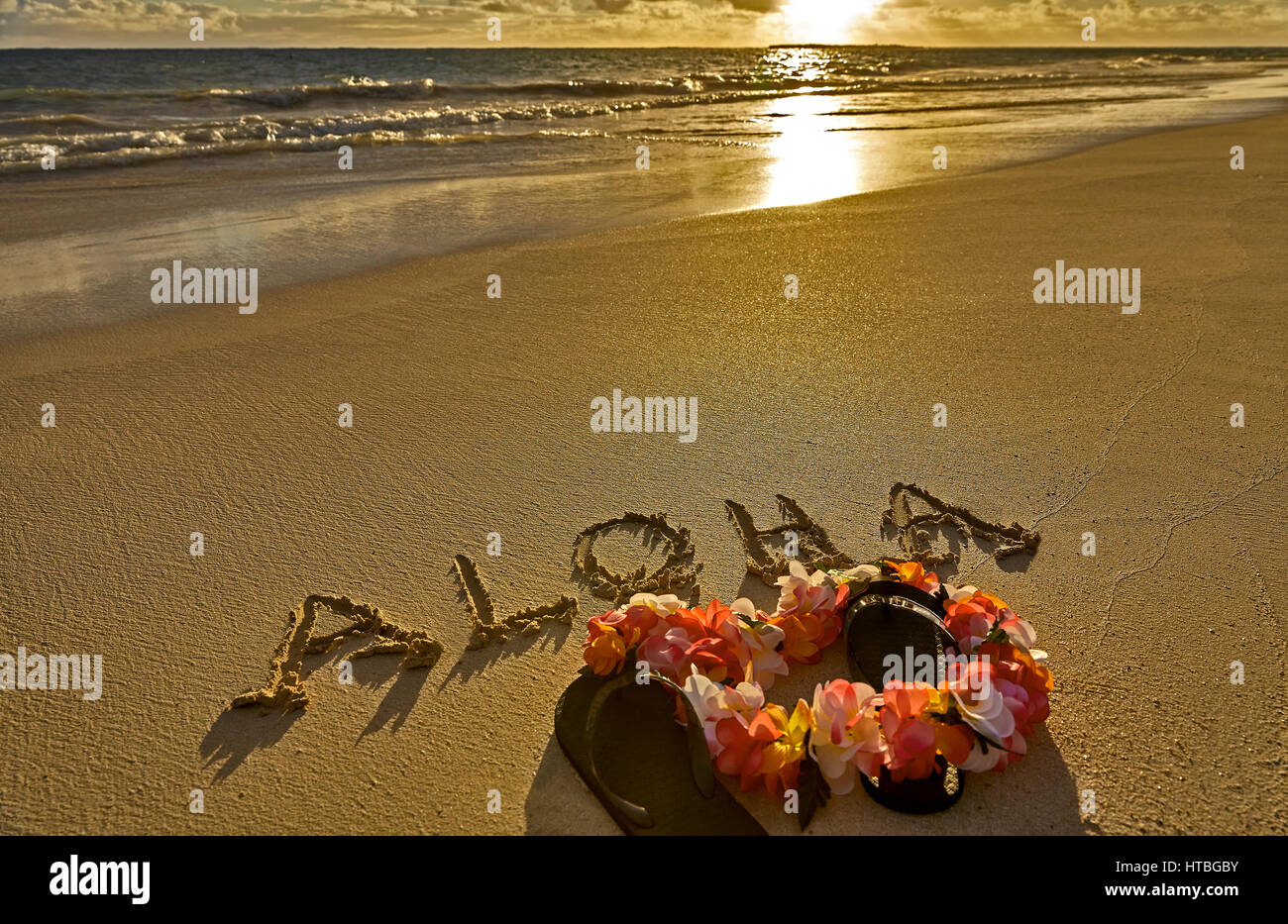 Tropical island beach aloha in sand with slippers Stock Photo