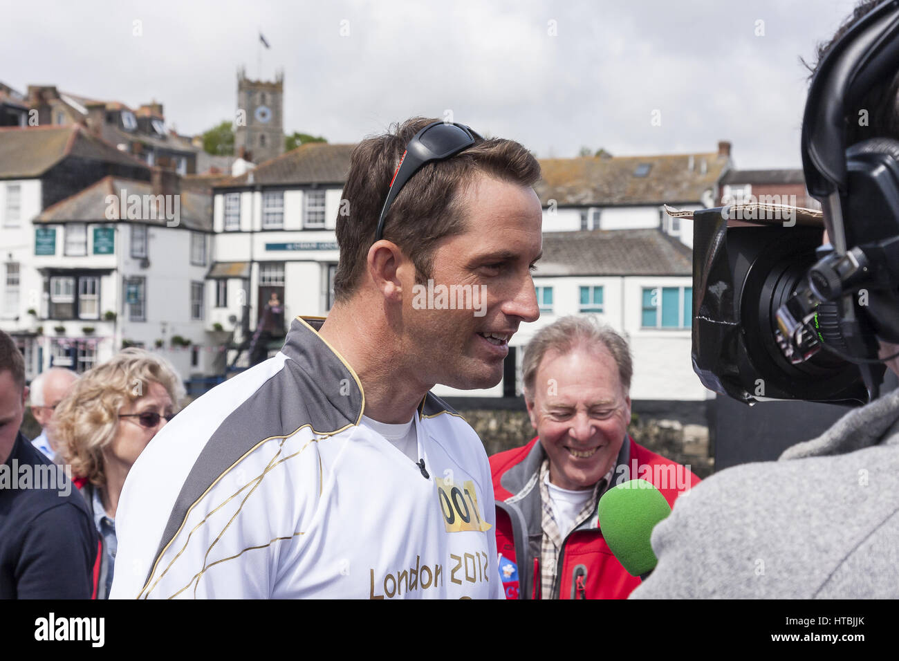 Sailor and Olympic medallist Sir Ben Ainslie being interviewed by the press and TV teams following the arrival of the 2012 Olympic Flame in Falmouth Stock Photo