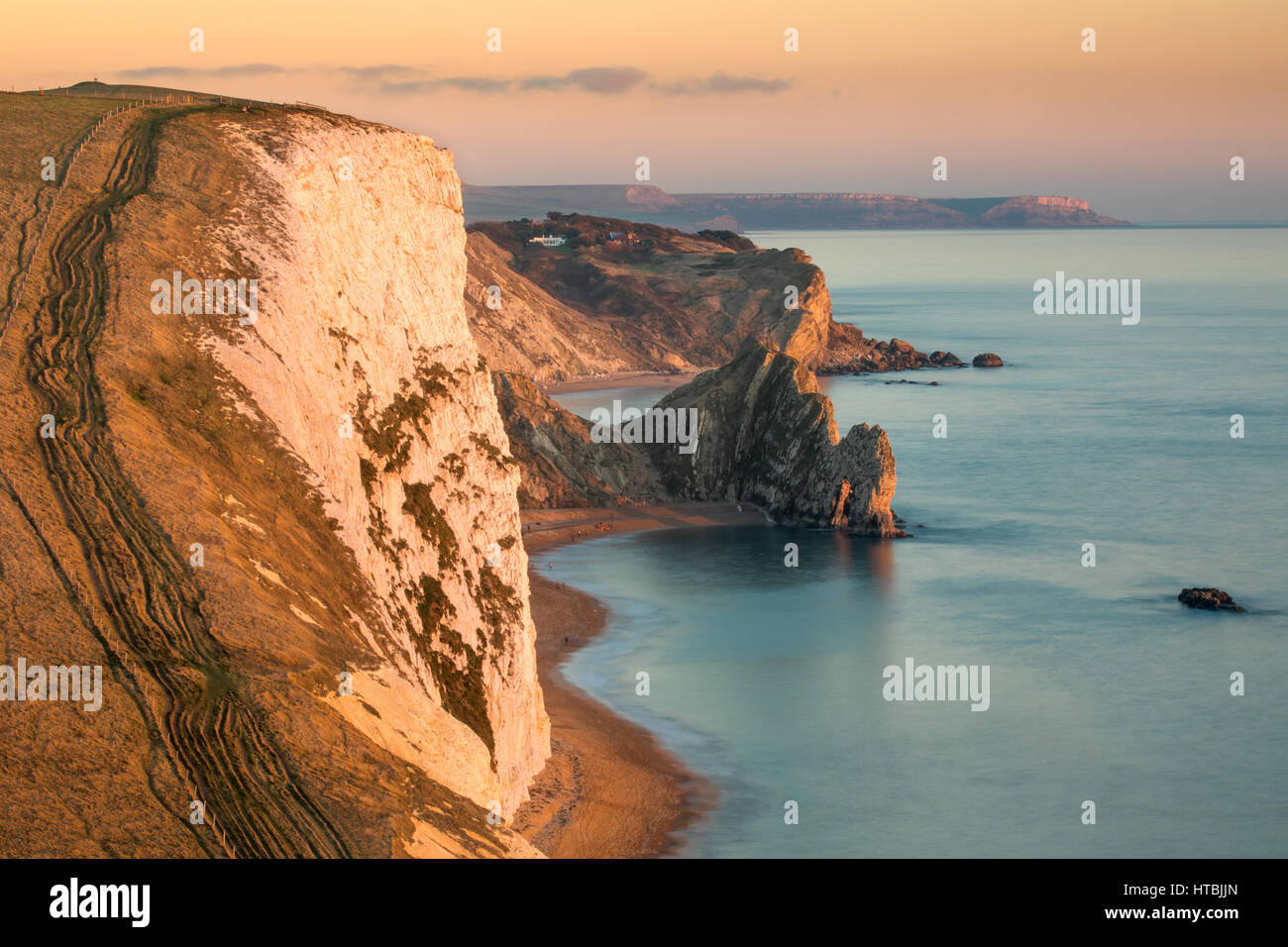 Durdle Door and St Oswald's Bay from Bat's Head at dusk, Purbeck, Jurassic Coast, Dorset, England, UK Stock Photo