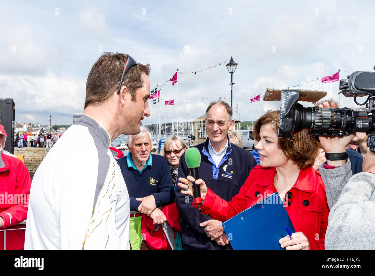 Sailor and Olympic medallist Sir Ben Ainslie being interviewed by the press and TV teams following the arrival of the 2012 Olympic Flame in Falmouth Stock Photo