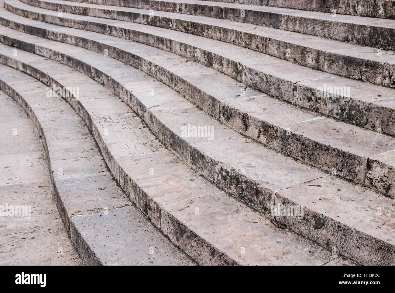 Curved stairs made of grey stone. Stock Photo
