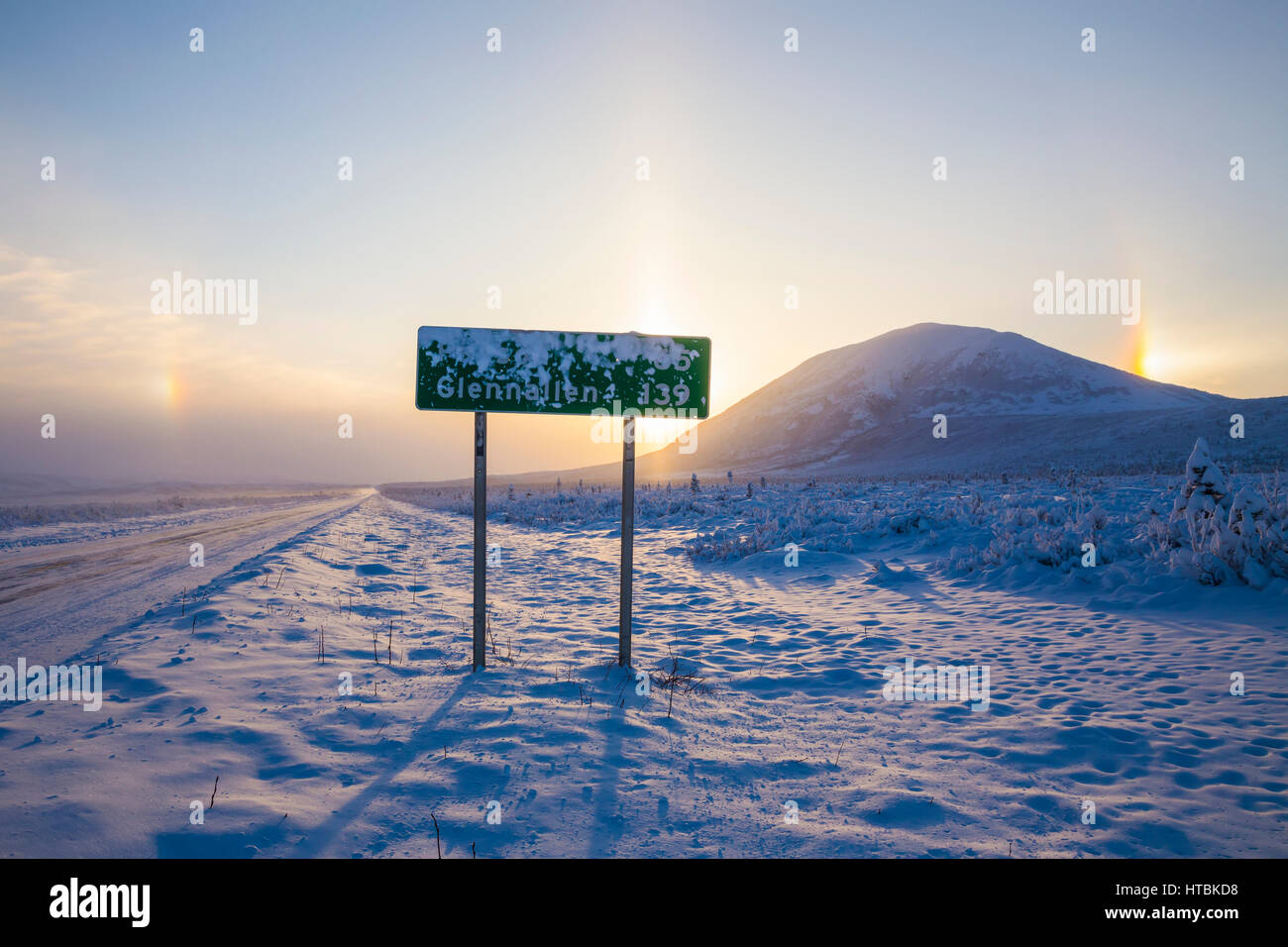 A Road Sign Partially Obscured By Frost Along The Richardson Highway With Parhelia (Sundogs) And Donnelly Dome In The Background On A Bitterly Cold... Stock Photo