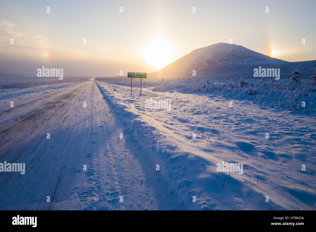 Parhelia (sundogs) surround the sun and Donnelly Dome in this winter view of the Richardson Highway south of Delta Junction Stock Photo