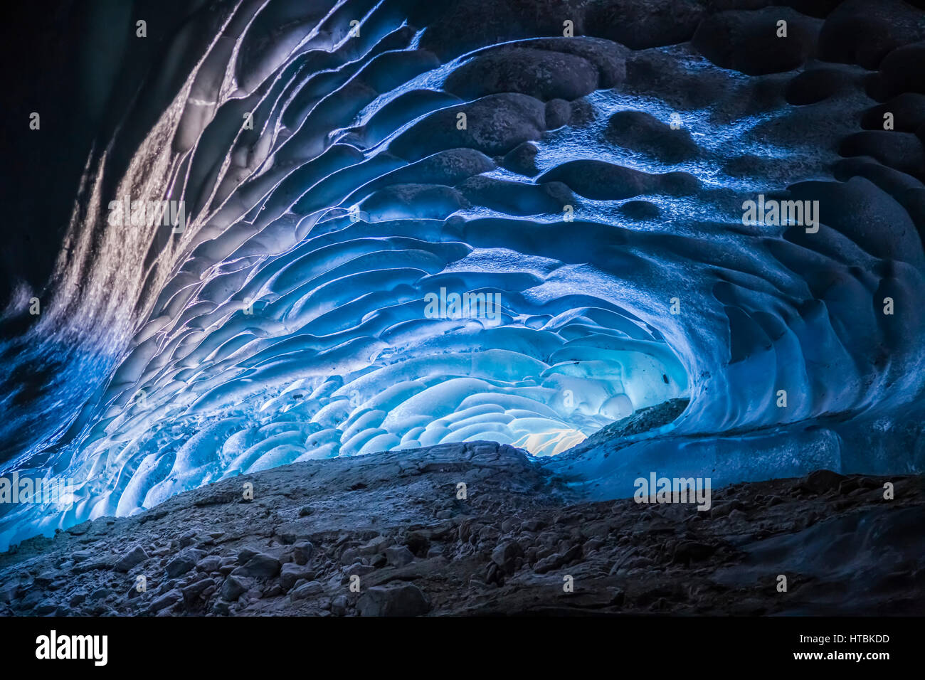 Light shines into a cave within Canwell Glacier in the Alaska Range
