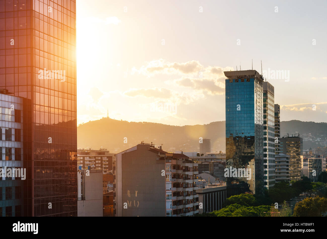 Barcelona, Catalonia, Spain - May 30, 2016: View of glass skyscrapers with reflection on Carrer de Tarragona Street near Spain square at sunset. Stock Photo