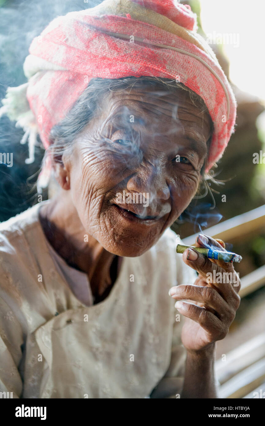 Myanmar (ex Birmanie). Inle lake. Woman smoking the cheroot the Burmese ...