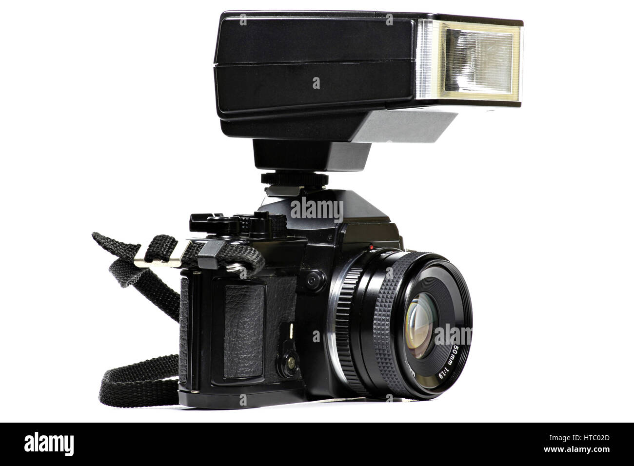 analogue singlelens reflex camera with flash attachment isolated on