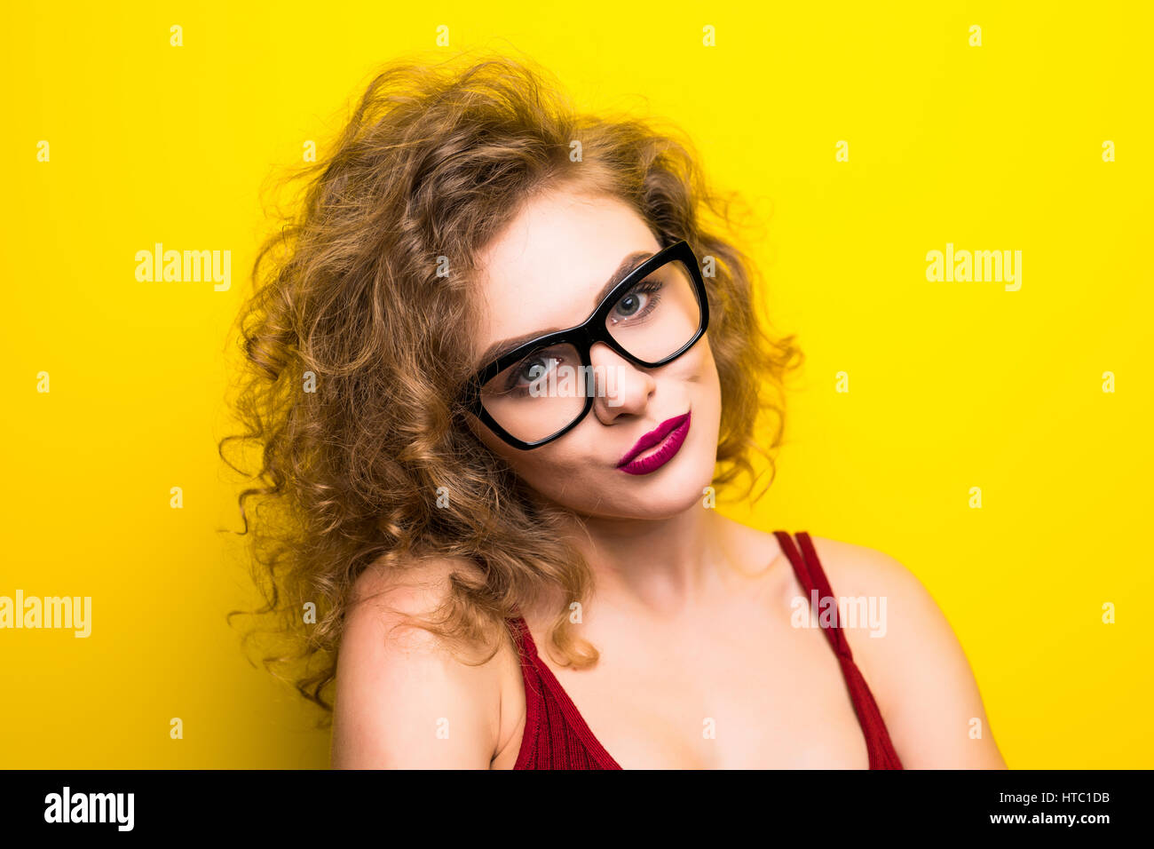 Young curly beauty woman posing on yellow background with different ...